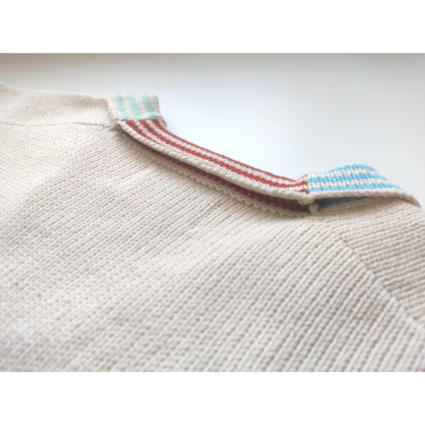 A close up shot of the knit t-shirt ''Simple Pleasures'', focusing on the coloured nape part.
