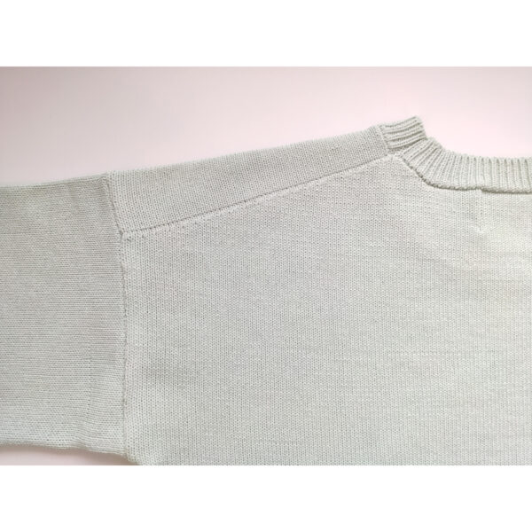 A close up shot of a mint coloured knit t-shirt, showing the nape side of the product.