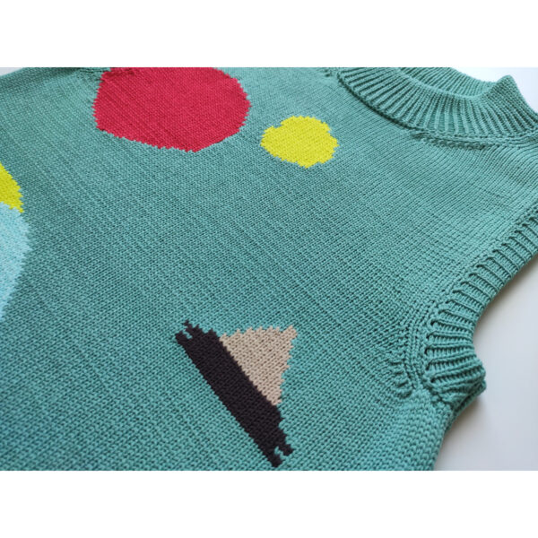 A close up shot of a dark mint coloured knit vest, with the additional colours of beige, red, yellow and black.