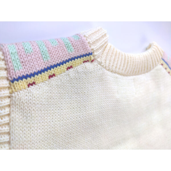 A close up shot of a beige coloured fair isle knit vest, showing the nape side of the product.