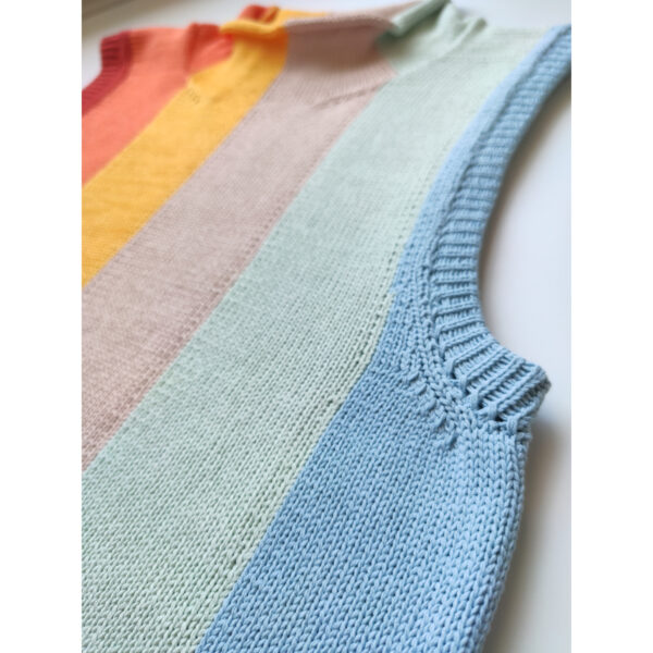 A close up shot of the armhole band of the rainbow coloured knit vest.