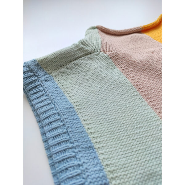 A close up shot of the nape of the rainbow coloured knit vest.