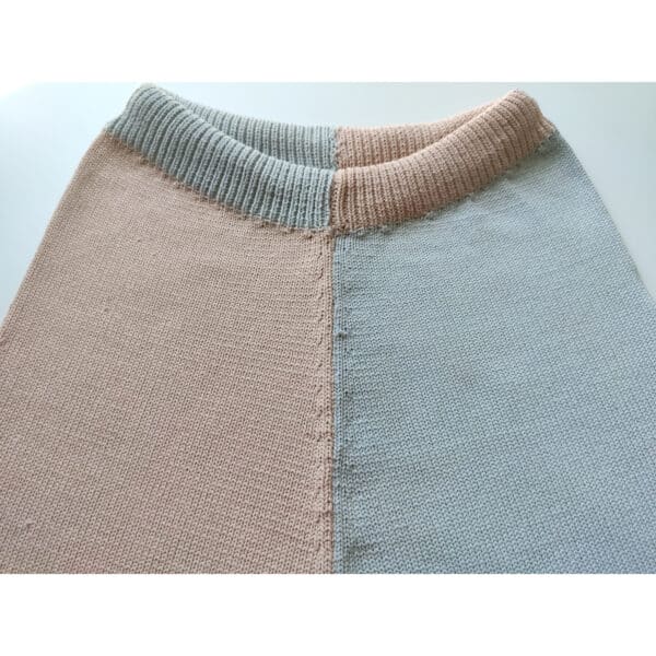 A close up shot of two coloured knit shorts, with one leg pink and the other blue.