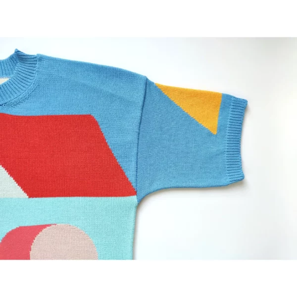 A close up shot of the handmade knit t-shirt showing the shapes in detail, the left side.