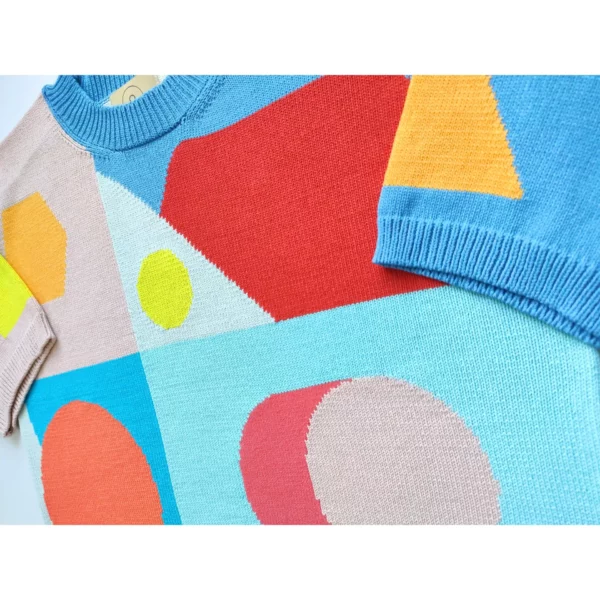 A close up shot of the handmade knit t-shirt showing the shapes in detail.
