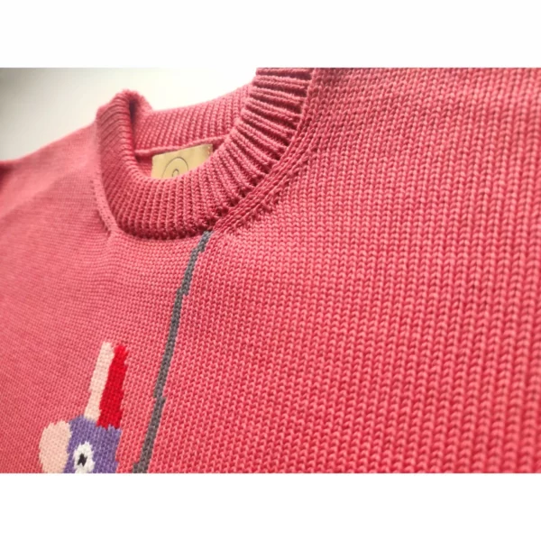 A close up shot of the Reap What You Swing sweater by Knyt, focusing on the fine details of the neck band.