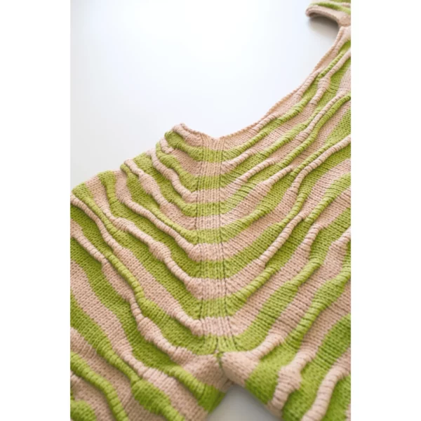 A close-up shot of Breezer (Caramel), focusing on the raglan sleeve joins and neckline. The bumpy texture and warm tones of Soft Caramel and Chartreuse highlight the intricate handmade craftsmanship.