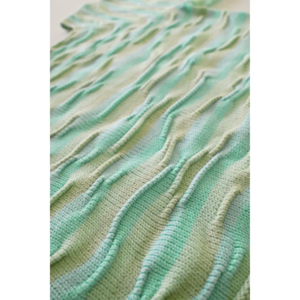 A close-up shot of Breezer (Mint), capturing the intricate bumpy texture in detail. The unique knitting technique and warm tones of Minty Ice Blue and Muted Olive come to life in this handmade piece.